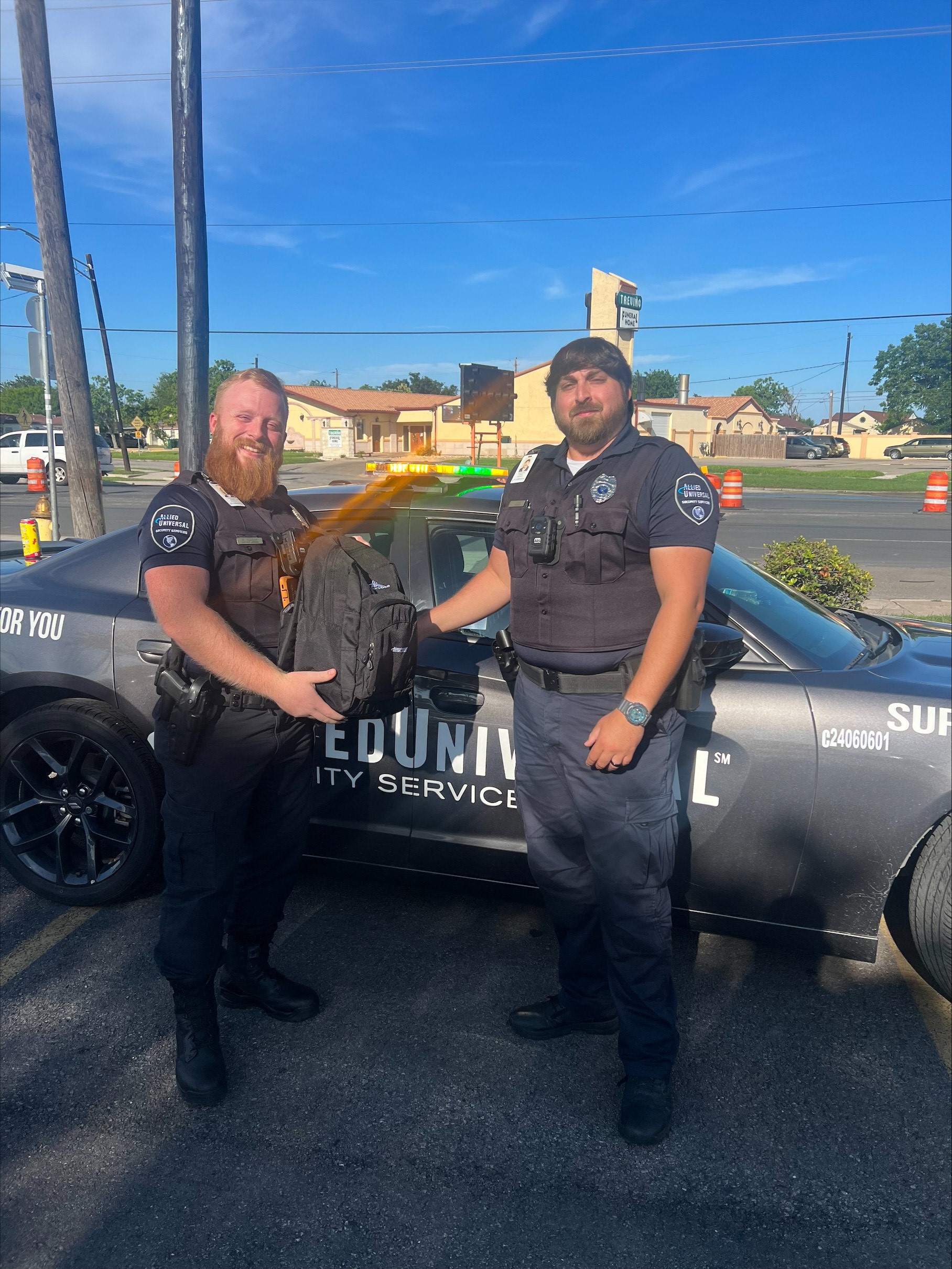 picture of a young security guard being thanked by another person