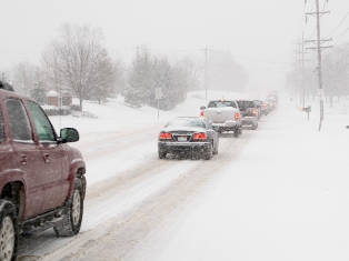 cars driving in blizzard