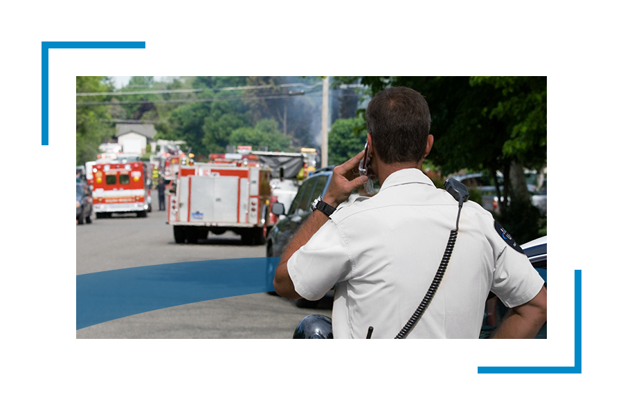 Back of a man looking at fire truck handling emergency preparedness/emergency response