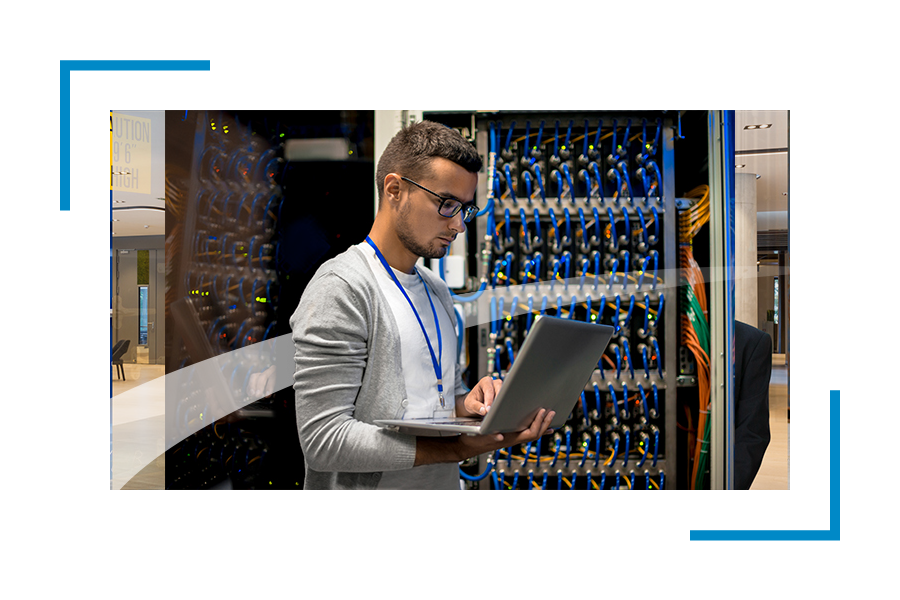 Man in a data center looking at the laptop