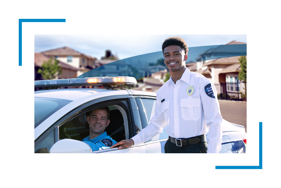 Two Allied Universal security vehicle patrol professionals one standing and one inside the mobile patrol car, doing security patrols, 